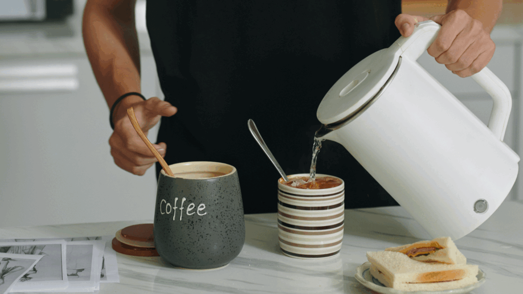 pouring water in coffee after grinding.